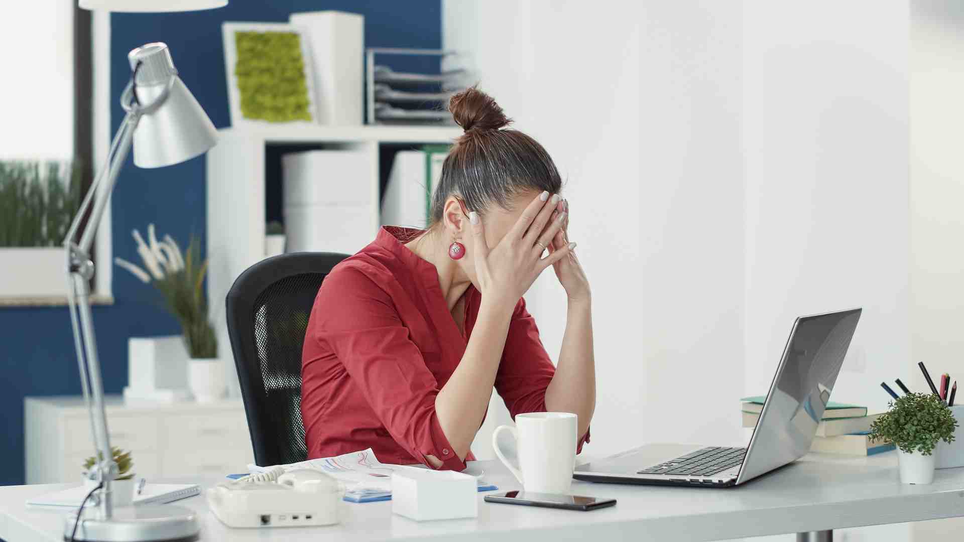 Stressed employee making mistake at office startup job, using sales statistics to do data research. Disappointed woman feeling displeased with business company failure, working on laptop.