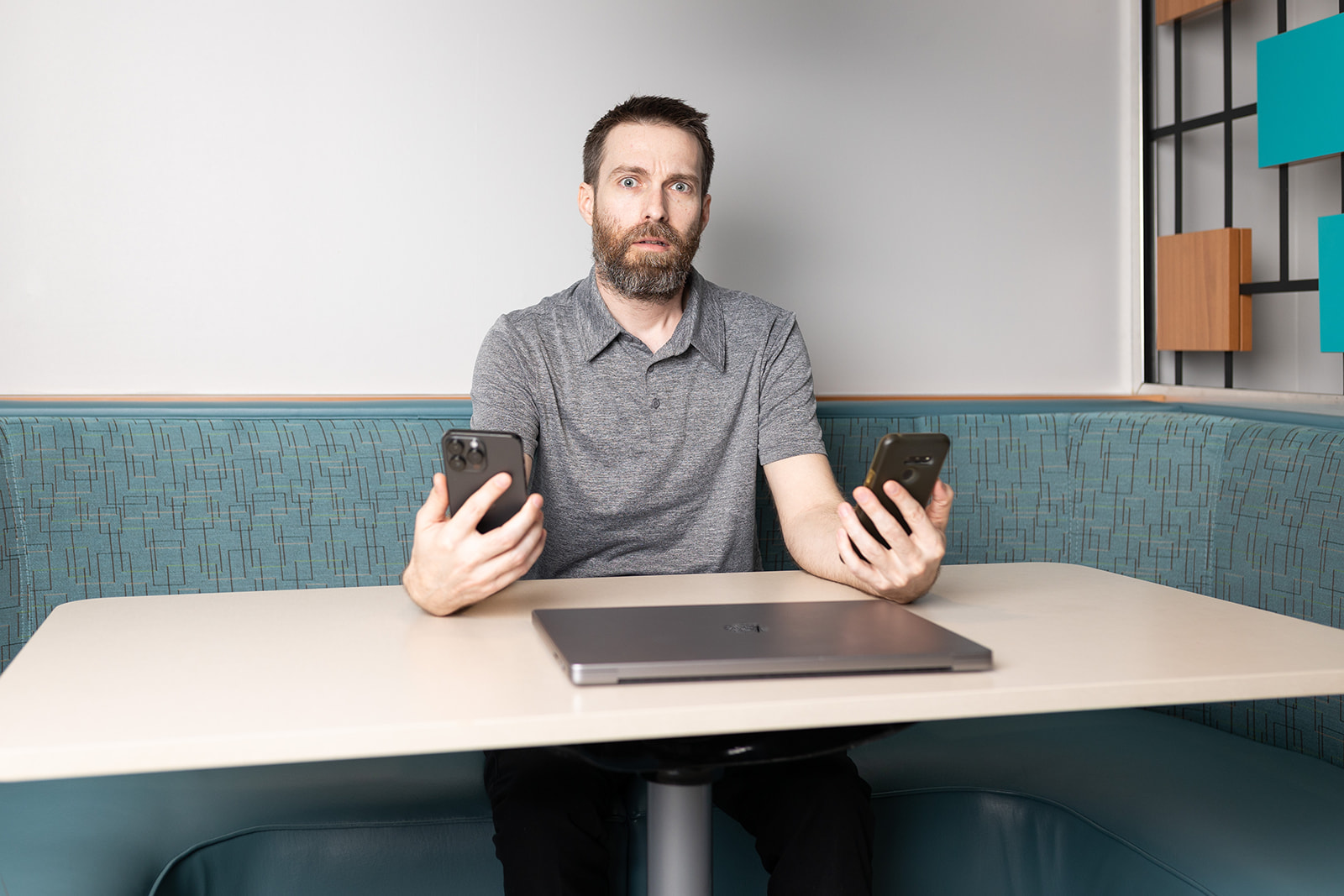 Man with Two Phones and Computer